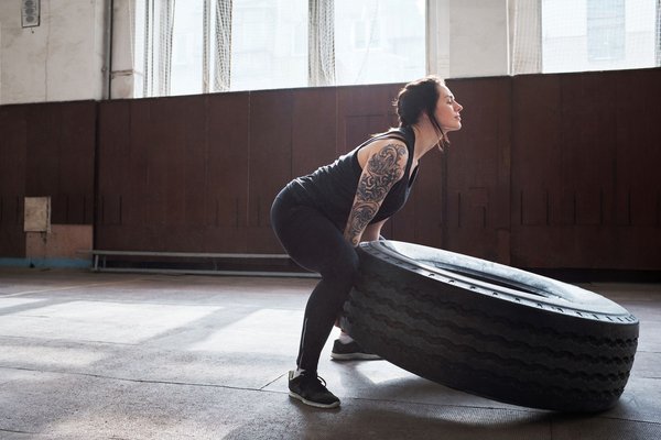 What are the advantages of high-load dynamic tension exercises for muscle growth?